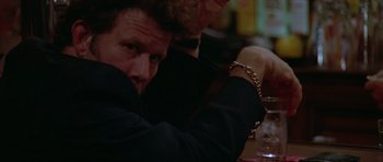 Movie still from “Short Cuts” (1993), directed by Robert Altman – A man sitting at a table with another man sitting next to him; Close Up shot, Low angle