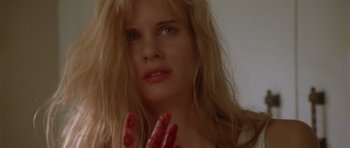 Movie still from “Short Cuts” (1993), directed by Robert Altman – A woman with long blonde hair and red nails; Close Up shot, Low angle