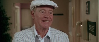 Movie still from “Short Cuts” (1993), directed by Robert Altman – An older man wearing a white hat and a striped jacket; Close Up shot, Low angle