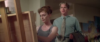 Movie still from “Short Cuts” (1993), directed by Robert Altman – A man and a woman standing next to each other in front of an easel; Medium shot, Low angle