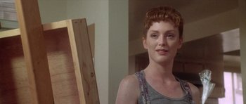 Movie still from “Short Cuts” (1993), directed by Robert Altman – A woman standing in front of an easel in a room; Close Up shot, Over the shoulder angle