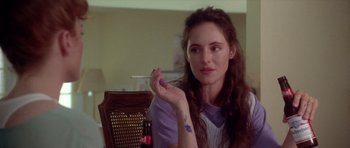 Movie still from “Short Cuts” (1993), directed by Robert Altman – A woman sitting at a table with a cigarette in her hand; Close Up shot, Over the shoulder angle