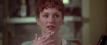 Movie still from “Short Cuts” (1993), directed by Robert Altman – A person holding a cigarette in their hand; Close Up shot, Over the shoulder angle