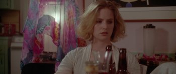 Movie still from “Short Cuts” (1993), directed by Robert Altman – A woman sitting at a table with a glass of beer; Close Up shot, Over the shoulder angle