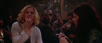 Movie still from “Short Cuts” (1993), directed by Robert Altman – A group of people sitting in a room smoking cigarettes; Close Up shot, Over the shoulder angle