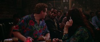 Movie still from “Short Cuts” (1993), directed by Robert Altman – A group of people sitting around a table; Medium shot, Over the shoulder angle