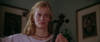 Movie still from “Short Cuts” (1993), directed by Robert Altman – A woman holding a violin in a room; Close Up shot, Low angle
