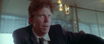 Movie still from “Short Cuts” (1993), directed by Robert Altman – A person wearing a suit and tie; Close Up shot, Low angle