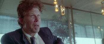 Movie still from “Short Cuts” (1993), directed by Robert Altman – A person wearing a suit and tie; Close Up shot, Low angle