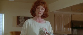 Movie still from “Short Cuts” (1993), directed by Robert Altman – A woman holding a hair dryer in a room; Close Up shot, Low angle