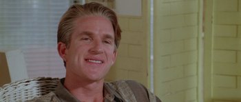 Movie still from “Short Cuts” (1993), directed by Robert Altman – A person smiling for the camera; Close Up shot, Low angle