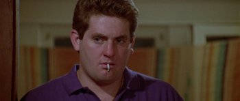 Movie still from “Short Cuts” (1993), directed by Robert Altman – A person with a cigarette in his mouth; Close Up shot, Low angle