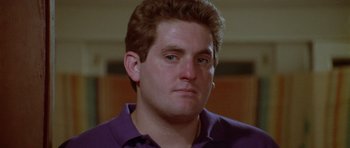 Movie still from “Short Cuts” (1993), directed by Robert Altman – A person wearing a purple shirt; Close Up shot, Low angle