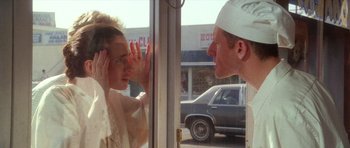 Movie still from “Short Cuts” (1993), directed by Robert Altman – A man and a woman looking at each other through a window; Close Up shot, Over the shoulder angle