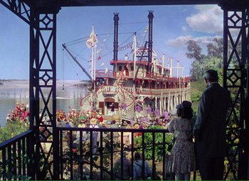 Movie still from “Show Boat” (1951), directed by George Sidney – Two people looking at a painting of a boat; Extreme Wide shot, Low angle