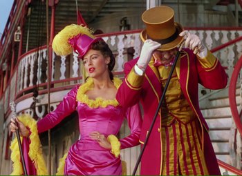 Movie still from “Show Boat” (1951), directed by George Sidney – A man and a woman dressed up in costumes; Medium shot, Low angle