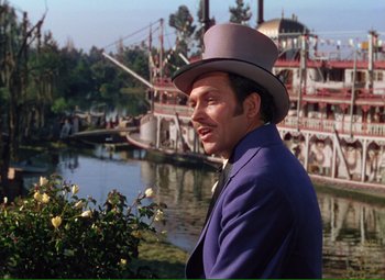 Movie still from “Show Boat” (1951), directed by George Sidney – A man wearing a purple suit and a hat; Medium shot, Over the shoulder angle