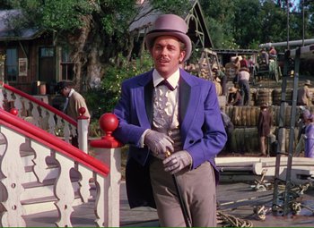 Movie still from “Show Boat” (1951), directed by George Sidney – A man in a purple jacket and a purple hat; Medium shot, Low angle