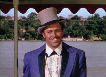 Movie still from “Show Boat” (1951), directed by George Sidney – A man wearing a top hat and a purple suit; Medium shot, Low angle