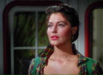 Movie still from “Show Boat” (1951), directed by George Sidney – A woman in a green shirt and plaid shirt looking to her left; Close Up shot, Over the shoulder angle