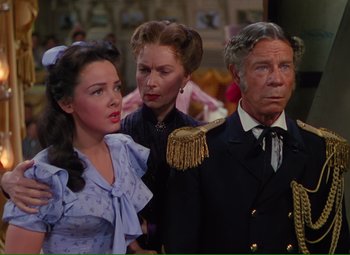 A man and two women standing next to each other