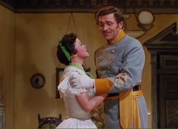 Movie still from “Show Boat” (1951), directed by George Sidney – A man and a woman are standing next to each other; Medium shot, Low angle