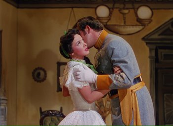 Movie still from “Show Boat” (1951), directed by George Sidney – A man and a woman dressed as cinderella and prince charming; Medium shot, Low angle