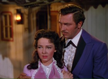 Movie still from “Show Boat” (1951), directed by George Sidney – A man and a woman standing next to each other; Medium shot, Over the shoulder angle