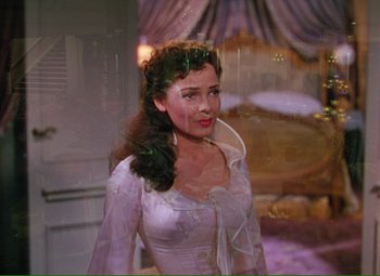 Movie still from “Show Boat” (1951), directed by George Sidney – A painting of a woman in a white dress; Medium shot, High angle