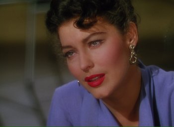 Movie still from “Show Boat” (1951), directed by George Sidney – A person wearing a blue shirt and red lipstick; Close Up shot, Over the shoulder angle