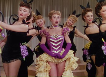 Movie still from “Show Boat” (1951), directed by George Sidney – A group of women dressed in vintage costumes; Medium shot, Low angle