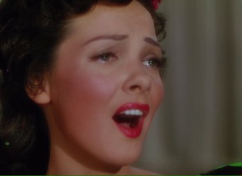 Movie still from “Show Boat” (1951), directed by George Sidney – A woman's face with her mouth open; Close Up shot, High angle