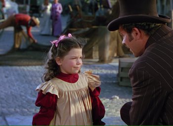 Movie still from “Show Boat” (1951), directed by George Sidney – A man and a little girl are talking to each other; Medium shot, Over the shoulder angle