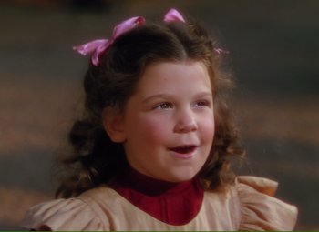 Movie still from “Show Boat” (1951), directed by George Sidney – A little girl wearing a pink dress and a pink bow in her hair; Close Up shot, High angle
