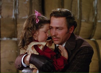 Movie still from “Show Boat” (1951), directed by George Sidney – A man holding a little girl in his arms; Close Up shot, High angle