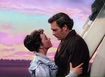 Movie still from “Show Boat” (1951), directed by George Sidney – A man and a woman standing next to each other; Medium shot, Low angle