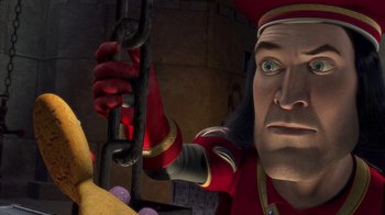 Movie still from “Shrek” (2001), directed by Vicky Jenson – An animated character is holding onto a chain; Close Up shot, High angle