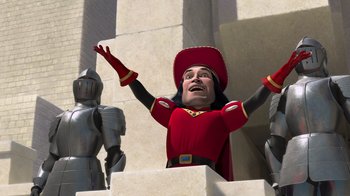 Movie still from “Shrek” (2001), directed by Vicky Jenson – A man in a red suit and a red cowboy hat; Medium shot, Low angle