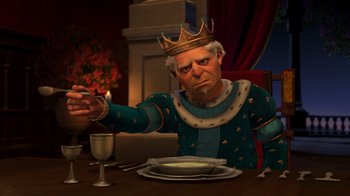 Movie still from “Shrek 2” (2004), directed by Andrew Adamson – An old man wearing a crown sitting at a dinner table; Medium shot, Over the shoulder angle