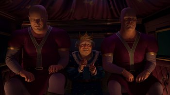 Movie still from “Shrek 2” (2004), directed by Andrew Adamson – A man in a crown sitting next to two men; Wide shot, High angle