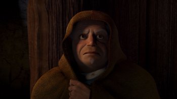 Movie still from “Shrek 2” (2004), directed by Andrew Adamson – An old man wearing a brown robe with a hood over his head; Close Up shot, Low angle