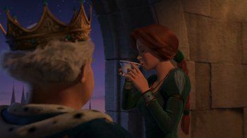 Movie still from “Shrek 2” (2004), directed by Andrew Adamson – A woman with a cup in her hand is standing next to a man with a crown on his head; Medium shot, Over the shoulder angle