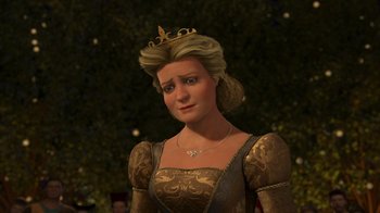 Movie still from “Shrek 2” (2004), directed by Andrew Adamson – A woman in a gold dress and a crown; Close Up shot, Over the shoulder angle