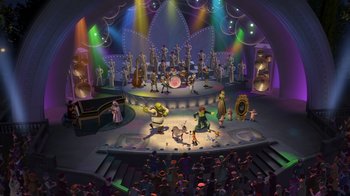 Movie still from “Shrek 2” (2004), directed by Andrew Adamson – An audience is gathered around a stage for a concert; Extreme Wide shot, High angle