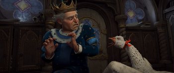 Movie still from “Shrek Forever After” (2010), directed by Mike Mitchell – An old man wearing a crown and holding a bird in his hand; Medium shot, High angle
