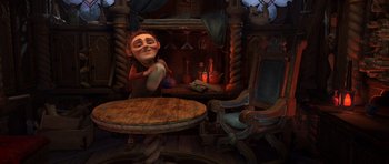 Movie still from “Shrek Forever After” (2010), directed by Mike Mitchell – An image of an animated character sitting at a table in front of a fire place; Wide shot, Over the shoulder angle