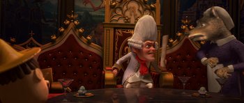 Movie still from “Shrek Forever After” (2010), directed by Mike Mitchell – A cartoon character sitting on a chair in front of a table; Medium shot, Over the shoulder angle