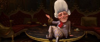 Movie still from “Shrek Forever After” (2010), directed by Mike Mitchell – A cartoon character sitting on top of a round table; Medium shot, Over the shoulder angle