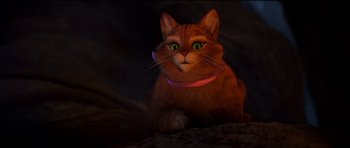 Movie still from “Shrek Forever After” (2010), directed by Mike Mitchell – An orange cat with green eyes sitting on the ground; Close Up shot, High angle