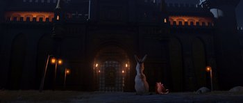 Movie still from “Shrek Forever After” (2010), directed by Mike Mitchell – Two animals sitting in front of a building at night; Extreme Wide shot, Over the shoulder angle